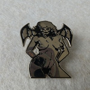 female figure with bat-like wings witch pins