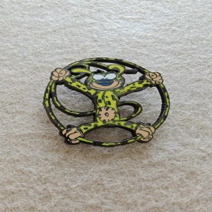 monkey character within a circular frame spinning cartoon pins