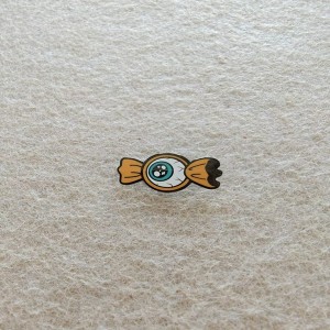 realistic-looking eyeball with a teal iris candy-shaped hard enamel pins