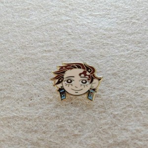 This is an anime-style enamel pin featuring a character’s head design