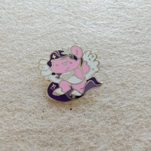a baby dragon or magical beast with a playful design cute hard enamel pins